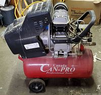 Left side view showing red tank, wheels, motor assembly and Can-Pro branding
