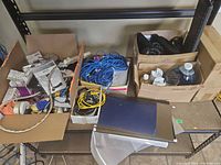 Overall view of three boxes with cables, discs, electronics and supplies
