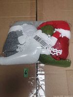 Factory-sealed bag containing three knit plush Christmas figures