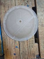 Top view of frosted floral glass shade showing pattern and center hole