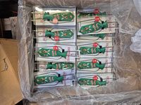 Box containing multiple packaged green Botskis bottle ties