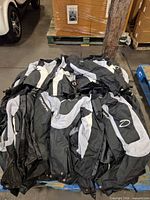 Pile of multiple Daymak motorcycle jackets on pallet
