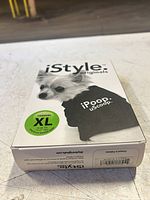 Front view of boxed dog shirt showing brand, graphic, size sticker