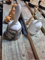 All three collectible bells on wooden surface