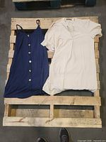 Both dresses laid out on pallet, full view
