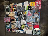 Overall view of entire mixed lot spread on pallet showing phone cases, accessories, jewellery and tools