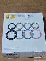Front of retail box showing four coloured holders and OtterBox branding