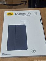 Front of sealed OtterBox Symmetry 360 Elite case packaging showing product window.