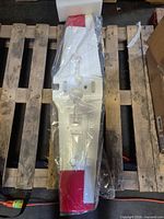 Top view of white/red EPP foam RC airplane wing replacement in plastic wrap