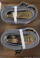 Two coiled grey E-ratchet straps showing ratchet mechanisms and hooks