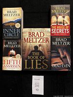 Group shot of five Brad Meltzer paperback novels