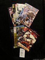 All 10 comics fanned out on black background