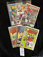 Six bagged comic books spread out