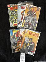 Six bagged comics laid out on black cloth