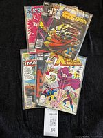 All six bagged comics fanned out on black backdrop