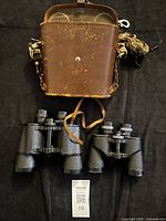 Two binoculars and leather case overview