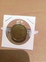 Obverse of Grey Cup loonie in flip holder