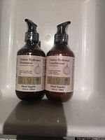 Front view of both Onion Hydrosol Shampoo and Conditioner bottles