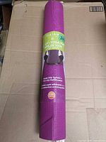 Rolled Gaiam yoga mat with full sleeve label visible