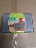 Front of yoga block with Gaiam label and damaged shrink wrap