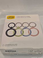 Front of sealed OtterBox Lumen Series AirTag holder 4-pack box showing color variety