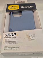Front of retail box showing light blue case and branding