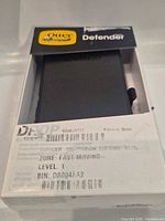 Front of boxed OtterBox Defender DROP+ case showing brand and model