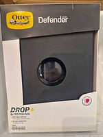 Front of boxed OtterBox Defender Series iPad case showing product name and features
