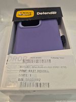 Front view of OtterBox Defender Series box showing purple case and warehouse label