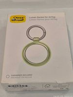 Front of OtterBox Lumen Series AirTag case retail box showing product image and color