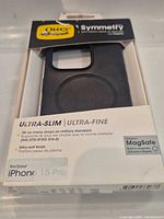 Front view of OtterBox Symmetry black case in original, slightly damaged retail packaging