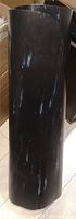 Rolled black marbled rubber mat standing upright