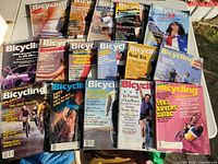 All 15 Bicycling magazines laid out front covers visible
