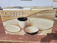 Front of sealed Corelle Hearthstone box showing branding and product image