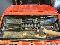 Open toolbox showing assorted tools in top tray