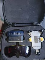 Kit contents in molded case: laser level, mounting bracket, safety glasses