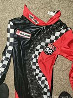 Front view of bodysuit showing colors, checker pattern, patches