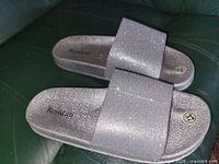 Top view of both silver glitter Roslan slides
