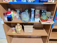 Overview of shelving with candles, holders, vases