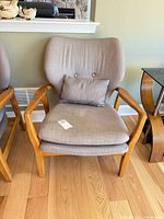 Front view of armchair showing overall design and cushions
