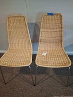 Both matching wicker and metal chairs front view