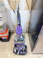 Full view of Dyson DC14 Animal upright vacuum with accessory basket