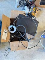 Cardboard box containing Samsung Blu-ray player, clip-on light, cables