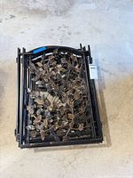 Stack of decorative metal fence panels with leaf design