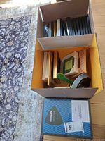two boxes of assorted small frames and boxed Nixplay frame