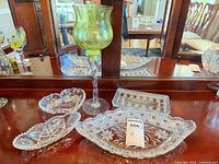Group shot showing candle holder and five glass dishes on dresser