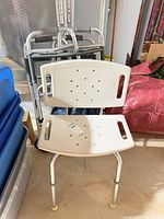 Shower chair in front of two walkers