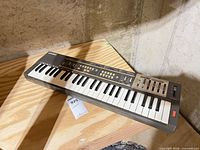 Full view of Casio Casiotone MT-100 keyboard on wooden surface