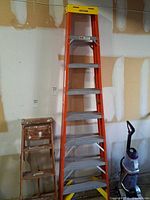 Full view of Werner 8' fiberglass ladder leaning against wall