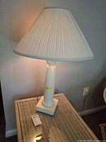 Full view of lamp on table showing base and shade